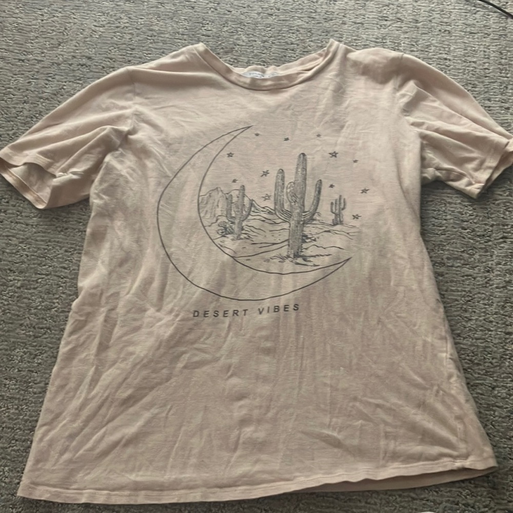 This is a cream t-shirt in a size kids small.